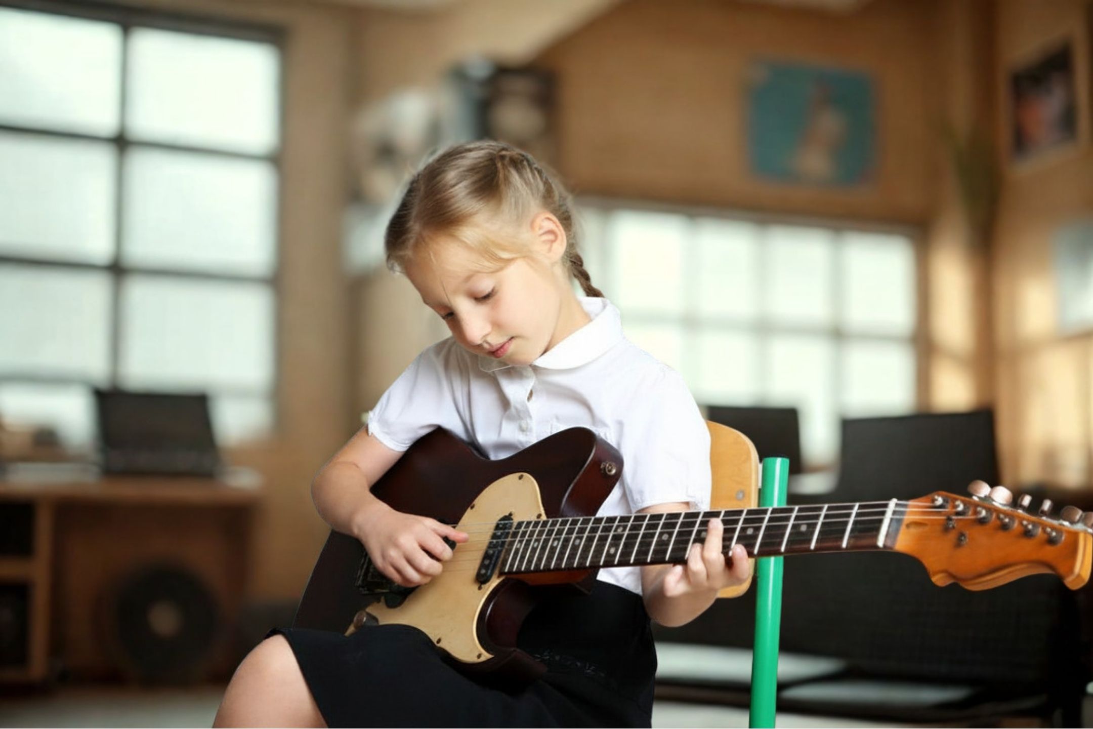 Young school child learning guitar